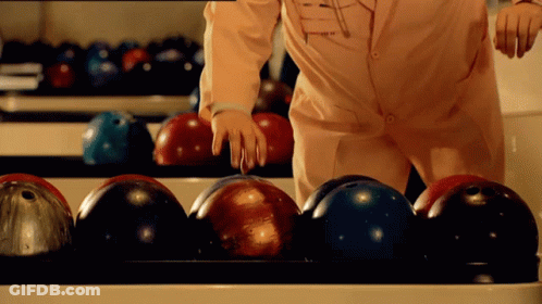Person In Bowling Alley Wearing Pink Converse Shirt GIF