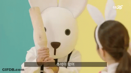 Person In Bunny Costume Holding Wooden Bat GIF