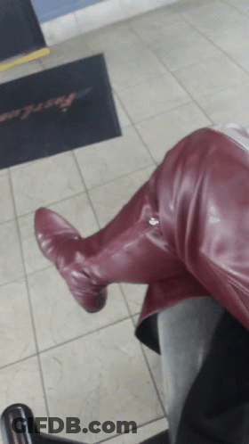 Person In Burgundy Boots Sitting On Chair Before Fast Lane Doormat GIF