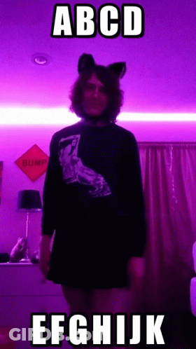 Person In Cat Ear Headband By Purple Wall Saying Bump GIF