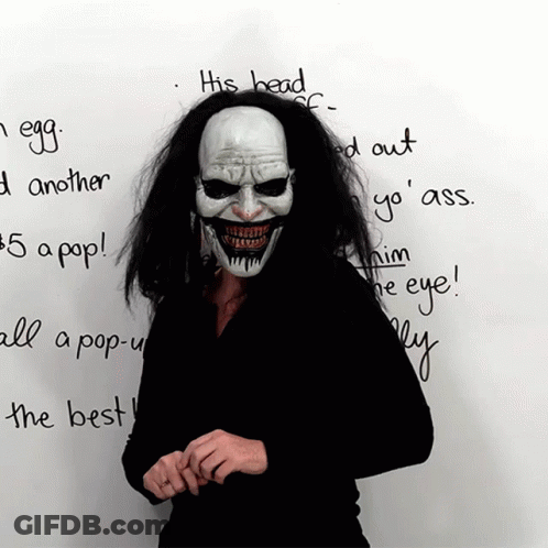 Person In Clown Mask Standing Before Whiteboard GIF