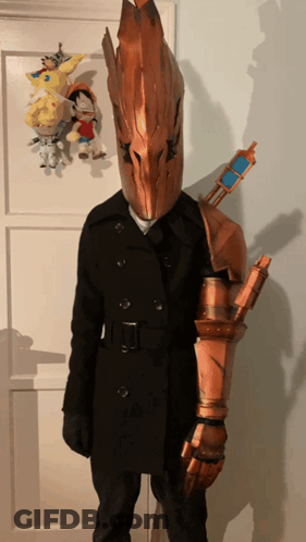 Person In Costume With Helmet And Sword On Arm GIF