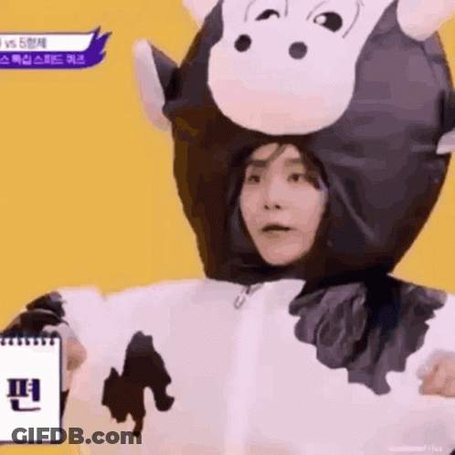 Person In Cow Costume Holding Notebook GIF