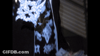 Person In Dark Room With Blue And White Pattern GIF