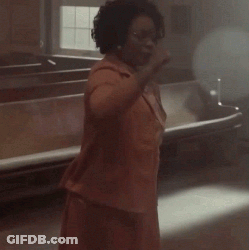 Person In Dark Room With Light Through Ceiling GIF