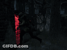 Person In Dark Room With Red Light Behind GIF