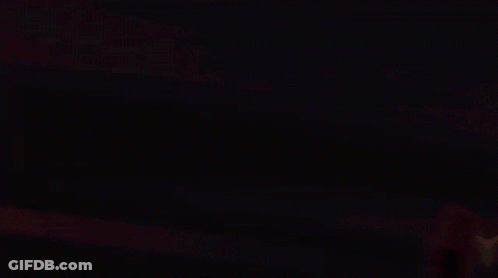 Person In Dark Room With Yellow Arrows GIF