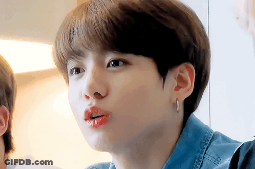 Person In Denim Shirt And Earrings Close Up GIF