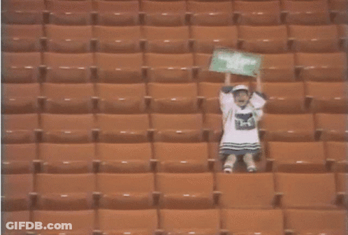 Person In Empty Stadium With H On Shirt GIF