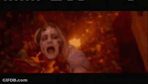 Person In Fire With Hands Outstretched Movie Scene GIF