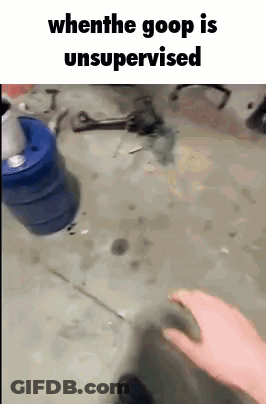 Person In Garage With Blue Bucket And Wrench GIF