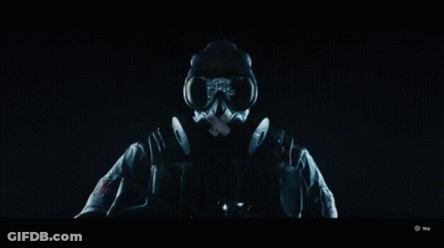 Person In Gas Mask In Dark Room GIF