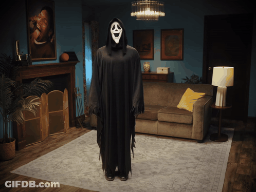 Person In Ghost Costume Beside Couch GIF