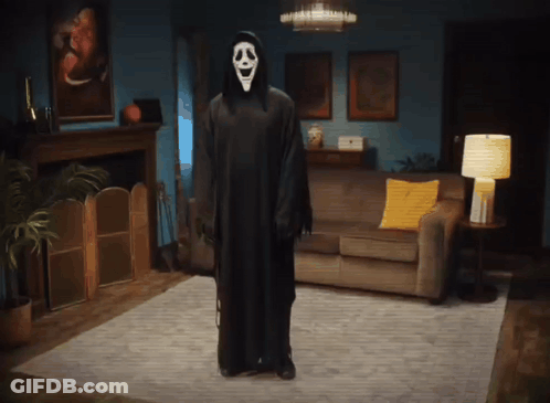 Person In Ghost Costume Standing In Living Room GIF
