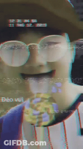 Person In Glasses And Hat Eating Candy Bar GIF