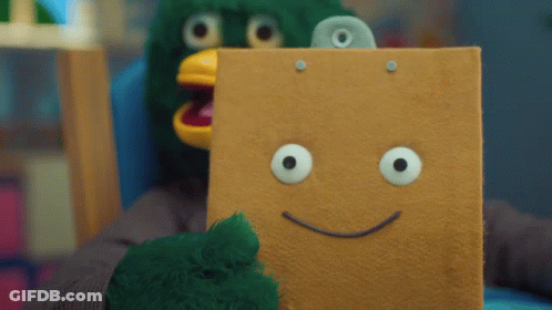 Person In Green Bird Costume Holding Cardboard Box With Smiley Face GIF