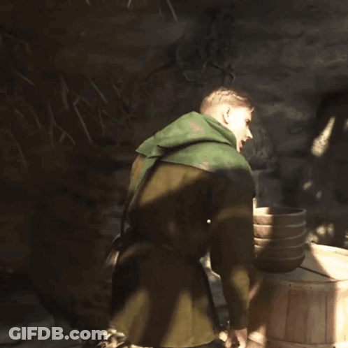 Person In Green Hooded Jacket Laying On Pile Of Leaves GIF