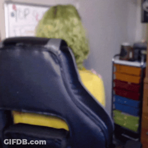 Person In Green Wig Sitting In Black Chair GIF