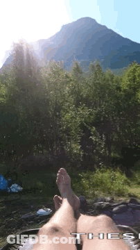 Person In Hammock With Feet Up Before Mountain GIF