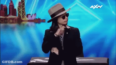 Person In Hat And Sunglasses With AXN On Blue Background GIF