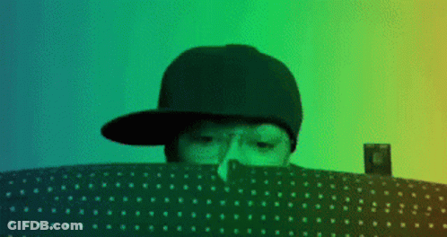 Person In Hat Looking Over Polka Dot Blanket GIF