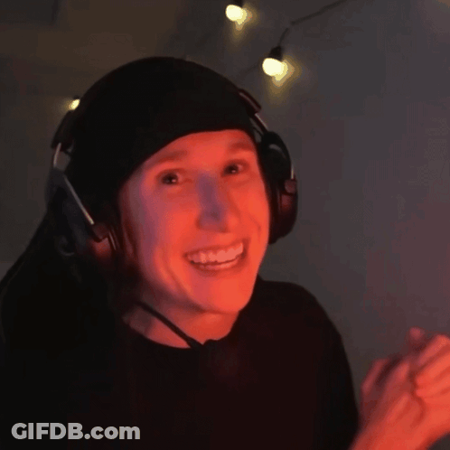 Person In Headphones And Beanie Smiling GIF