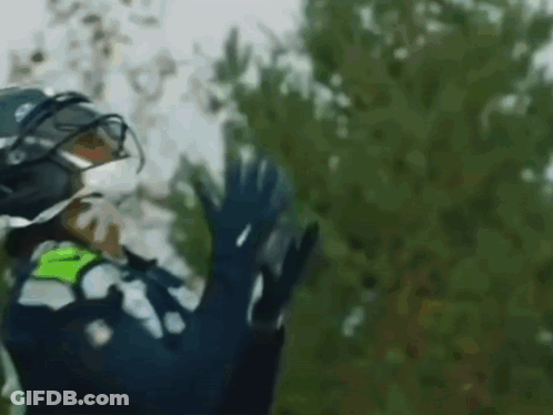 Person In Helmet And Gloves Waving GIF