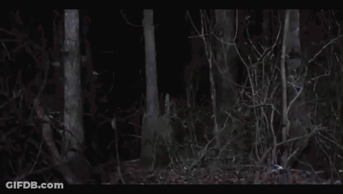 Person In Hockey Mask Holding Sword In Dark GIF