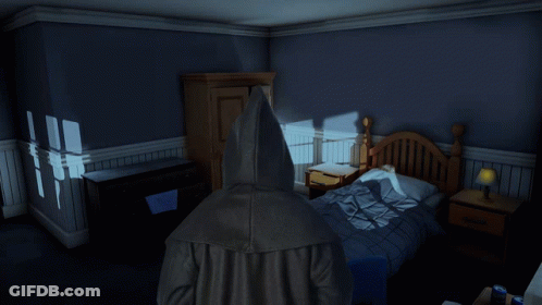 Person In Hooded Jacket Standing In Bedroom GIF
