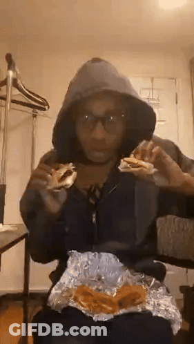 Person In Hoodie Eating Sandwich GIF