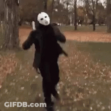 Person In Jason Voorhees Costume Walking In Park GIF