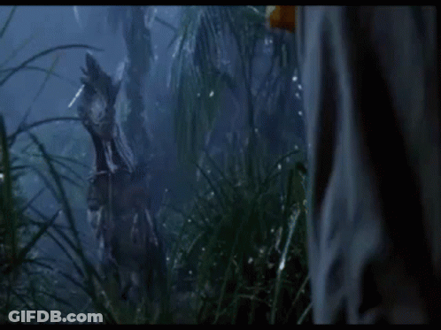 Person In Jungle With Dinosaur Statue GIF