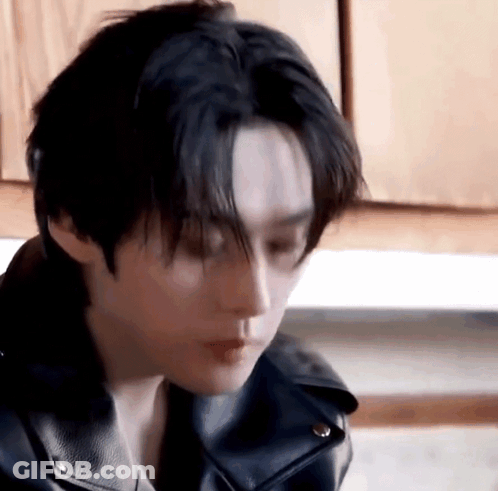 Person In Leather Jacket Looking Down GIF