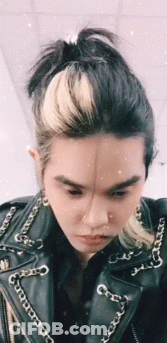 Person In Leather Jacket With Chains GIF