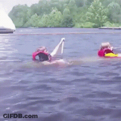 Person In Life Vest Floating On Raft GIF