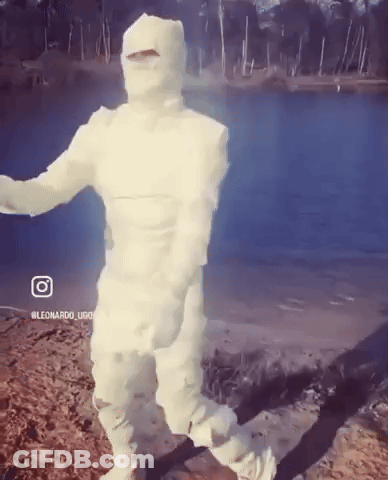 Person In Mummy Costume Standing On Beach GIF