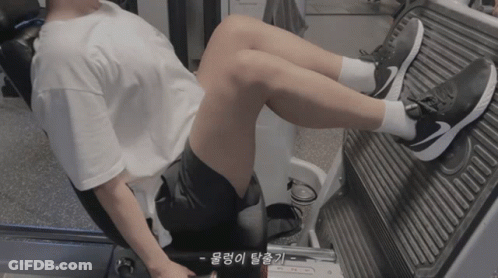 Person In Nike Shoes Sitting On Machine With Legs Up GIF