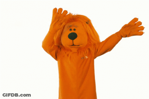Person In Orange Lion Costume With Confetti GIF