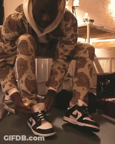 Person In Paisley Pants Tying Shoes GIF