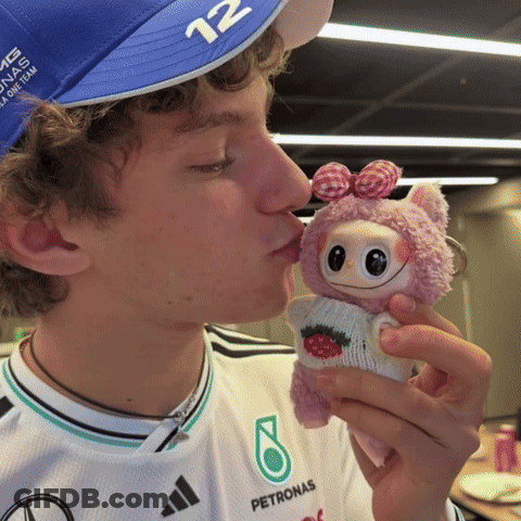Person In Petronas Shirt Kissing Stuffed Animal GIF