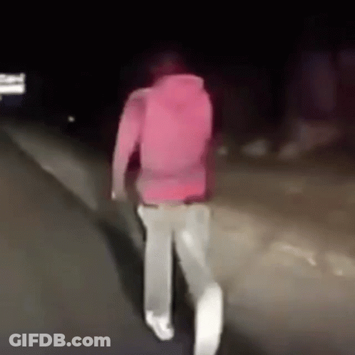 Person In Pink Hoodie Walking At Night GIF