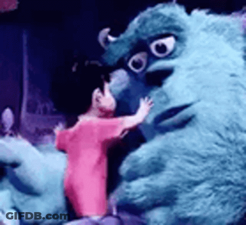 Person In Pink Shirt Hugging Stuffed Monster GIF