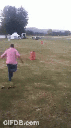 Person In Pink Shirt Running In Field GIF
