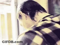 Person In Plaid Shirt Looking Down GIF