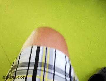 Person In Plaid Shirt On Green Floor GIF