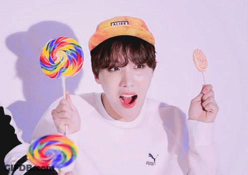 Person In Puma Sweatshirt Holding Three Lollipops GIF