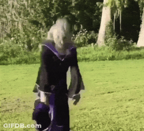 Person In Purple And Black Outfit In Grassy Field GIF