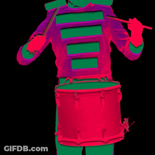 Person In Purple And Green Uniform Playing Red Drum GIF