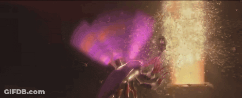 Person In Purple Cape Standing In Front Of Door With Purple Light GIF
