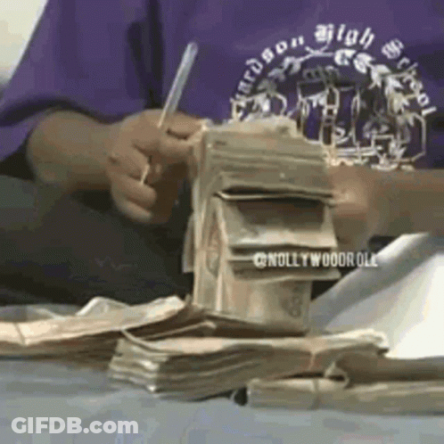 Person In Purple Shirt Writing On Money GIF